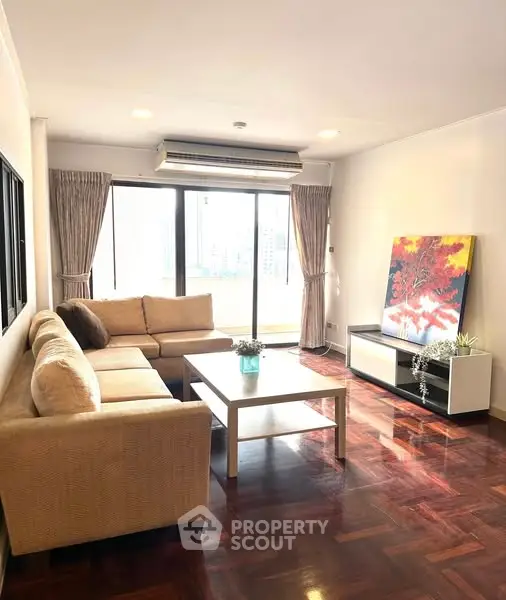 Spacious living room with large windows and cozy sectional sofa