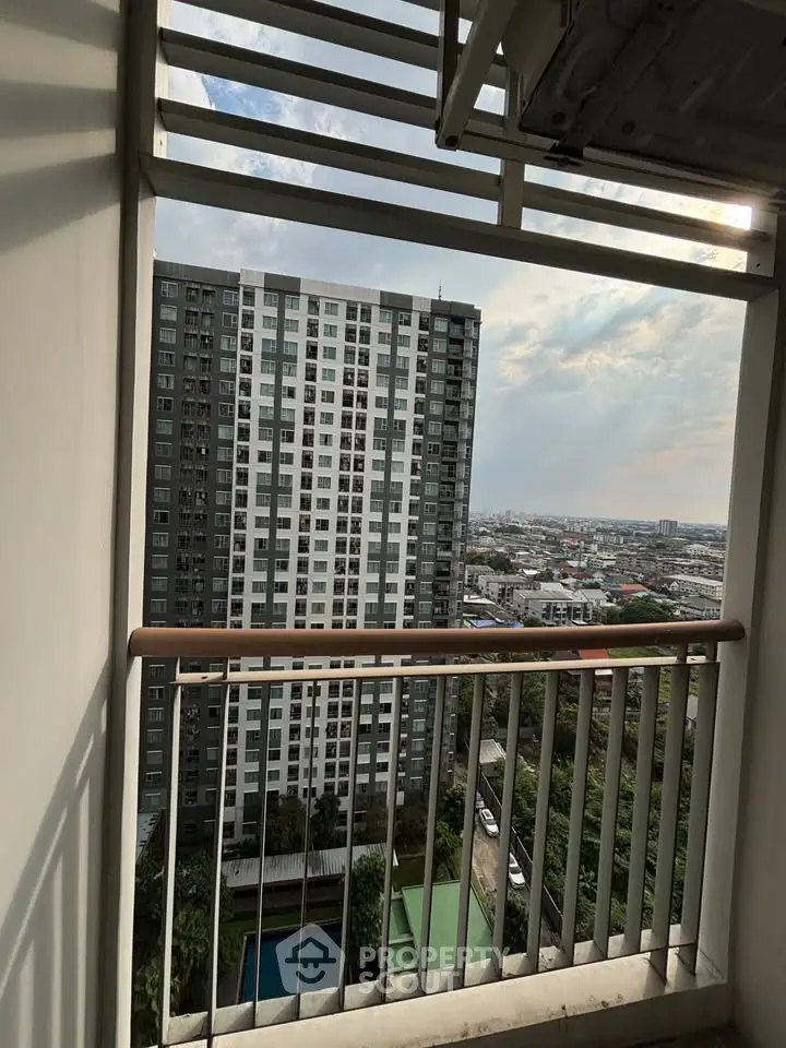 Stunning high-rise apartment view with cityscape and pool below, perfect for urban living.