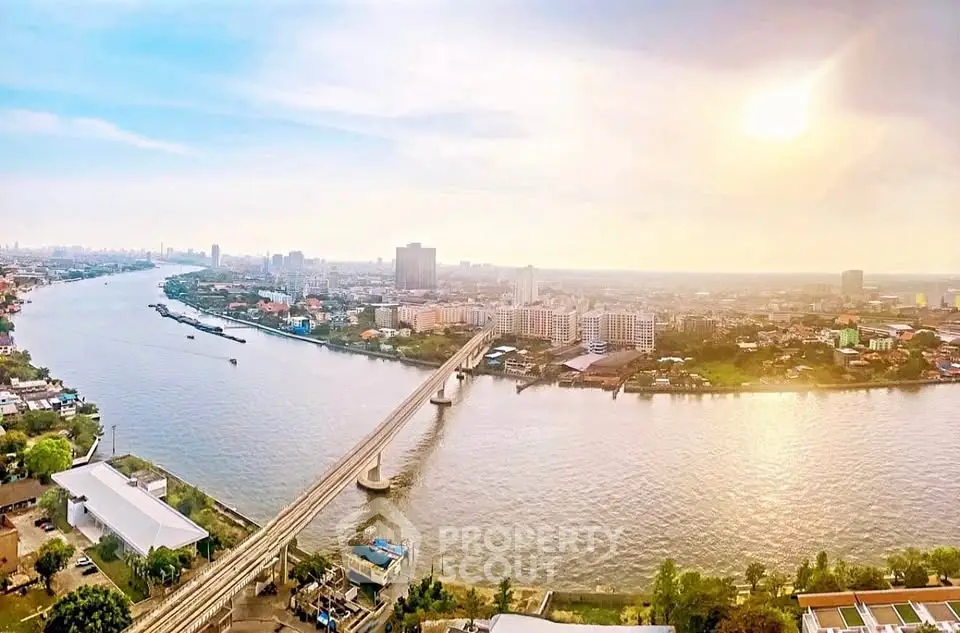 Stunning panoramic river view with cityscape and bridge at sunset, perfect for urban living enthusiasts.