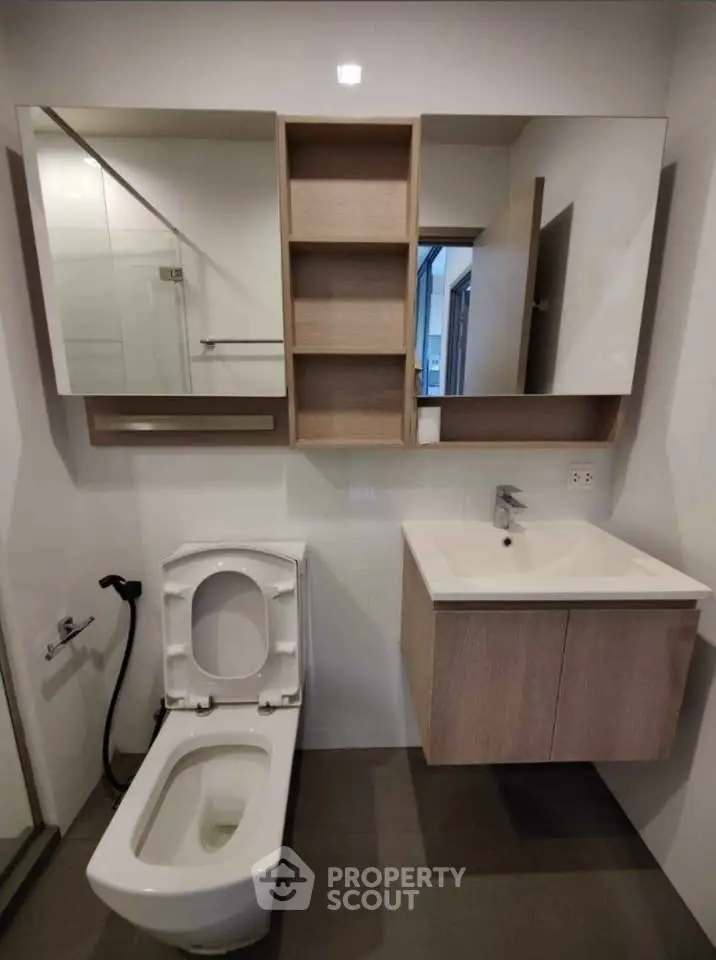 Modern bathroom with sleek fixtures and wall-mounted vanity in contemporary apartment.