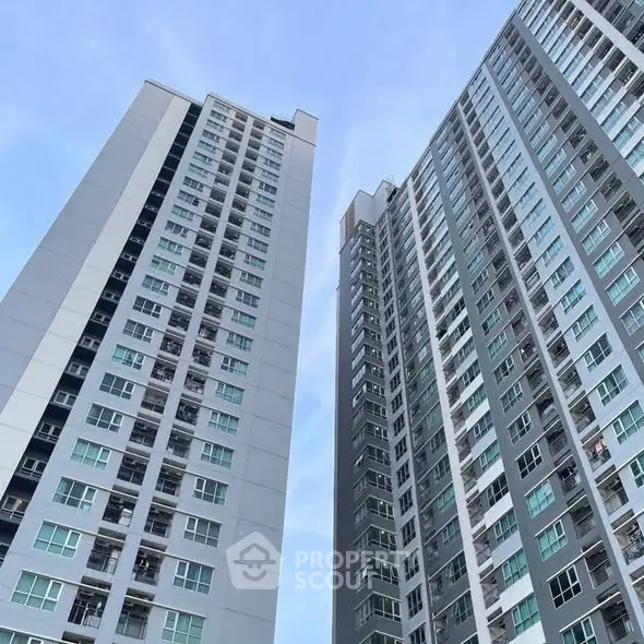 Modern high-rise residential buildings against a clear blue sky.