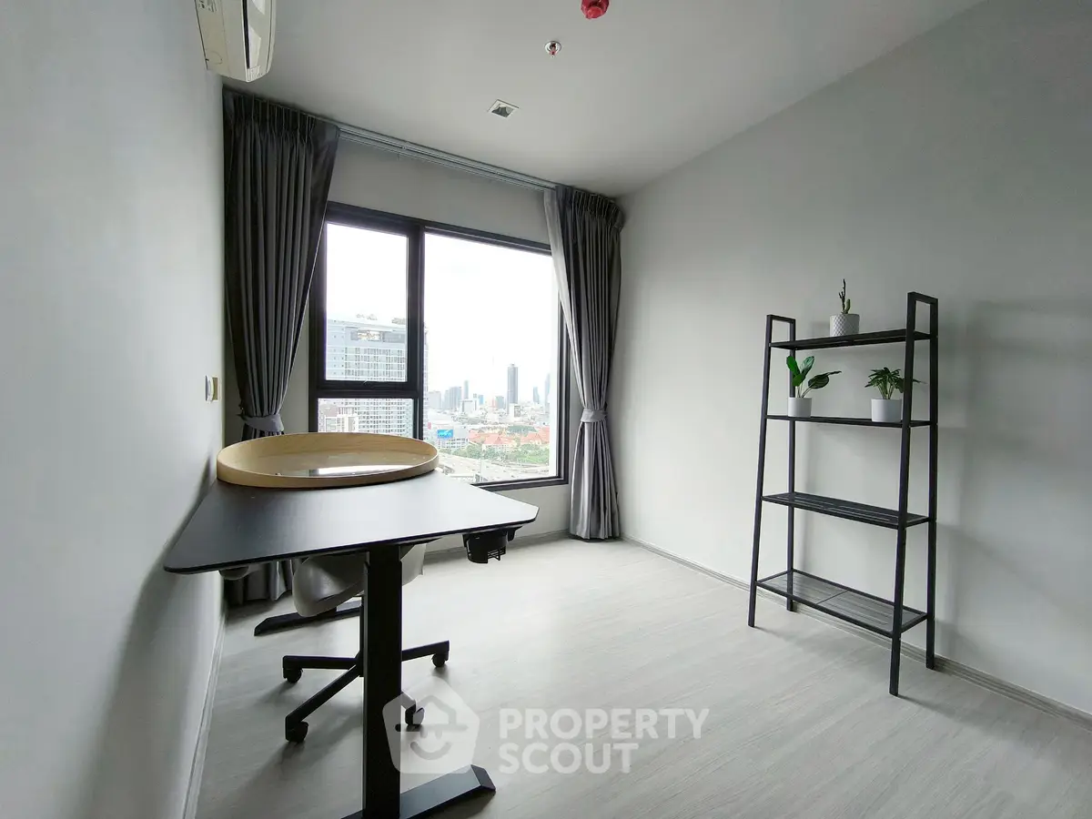 Modern study room with city view, sleek desk, and minimalist decor.