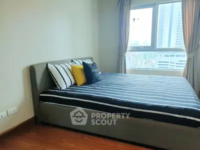 Modern bedroom with city view and stylish decor in high-rise apartment