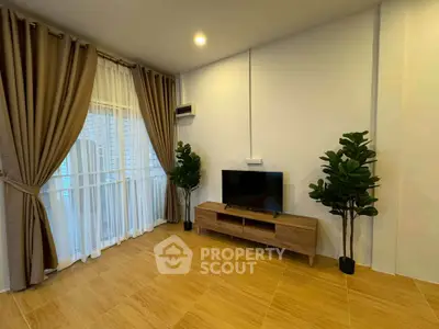 Spacious living room with modern decor and large windows for natural light.