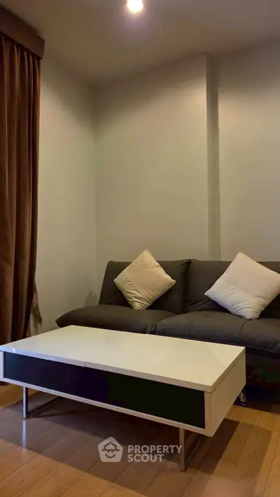 Cozy living room with modern sofa and sleek coffee table, perfect for relaxation.