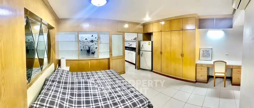 Spacious studio apartment with modern kitchen and ample storage space