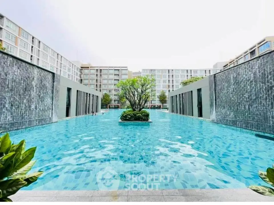 Luxurious apartment complex with stunning pool and modern architecture.