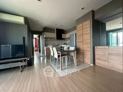 Modern open-plan living room with dining area and sleek kitchen design