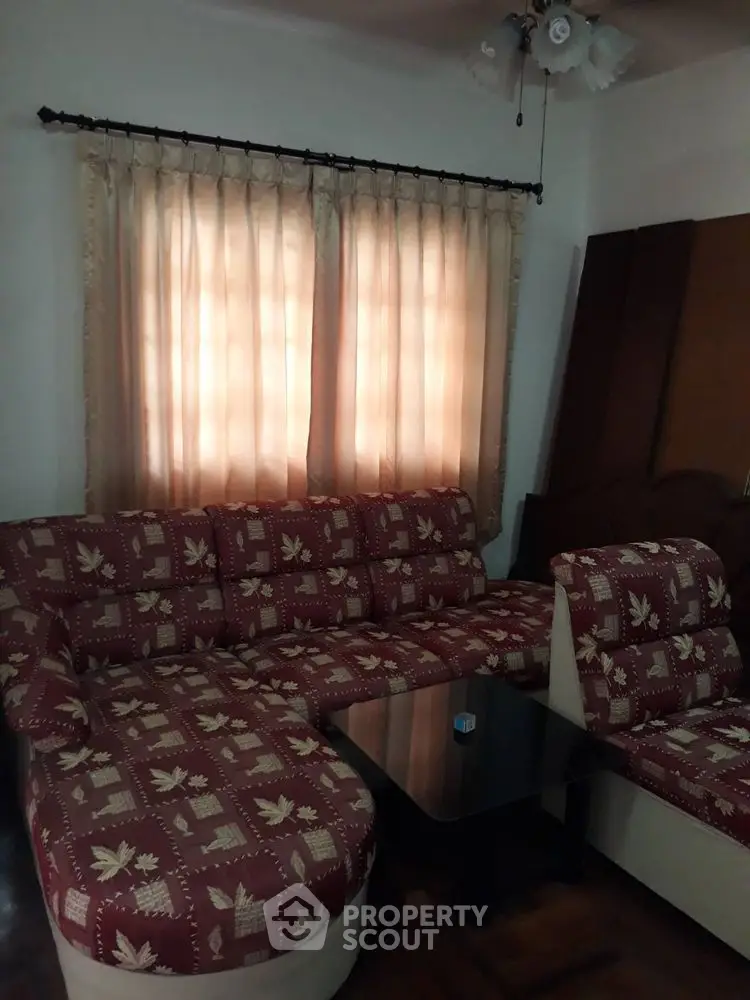 Cozy living room with patterned sofa and soft lighting