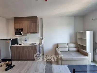 Modern studio apartment with compact kitchen and cozy living area