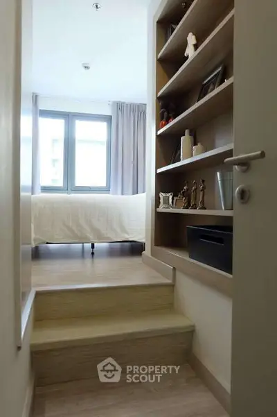 Charming bedroom with built-in shelving and natural light