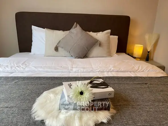 Cozy bedroom with stylish decor and plush bedding, perfect for relaxation.