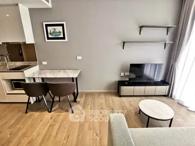 Modern living room with sleek furniture and open kitchen layout, perfect for urban living.