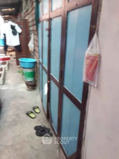 Rustic exterior with wooden doors and casual outdoor setting