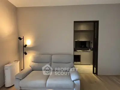 Modern living room with cozy sofa and open kitchen layout