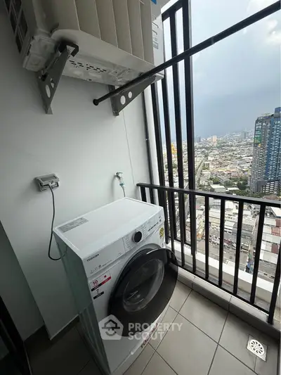 High-rise apartment balcony with washing machine and city view