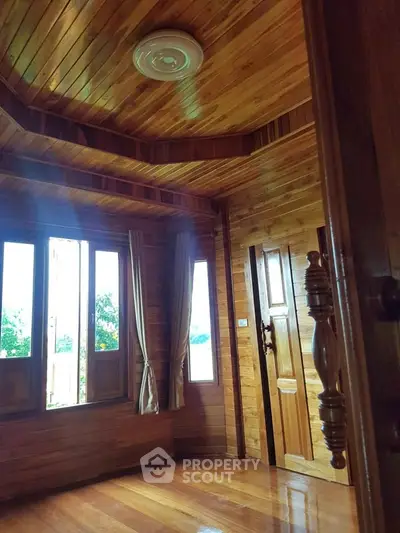 Charming wooden interior with large windows and natural light