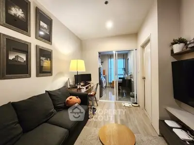 Cozy living room with modern decor and open view to laundry area
