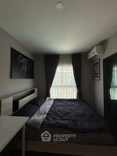 Cozy bedroom with modern decor and natural light, featuring a comfortable bed and stylish curtains.