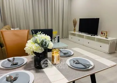 Stylish modern living room with elegant dining setup and cozy seating area.