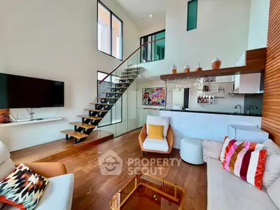 Modern living room with stylish staircase and open kitchen layout