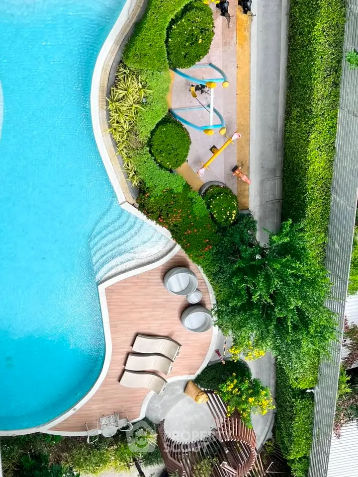 Luxurious aerial view of a modern swimming pool with lush greenery and stylish poolside seating.