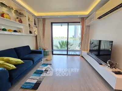 Modern living room with balcony view, stylish decor, and natural light.