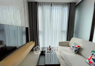 Modern living room with sleek TV setup and stylish sofa, perfect for relaxation.