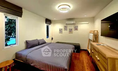 Cozy bedroom with modern decor and wooden flooring