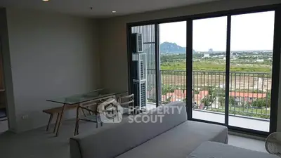 Modern living room with large windows and scenic balcony view