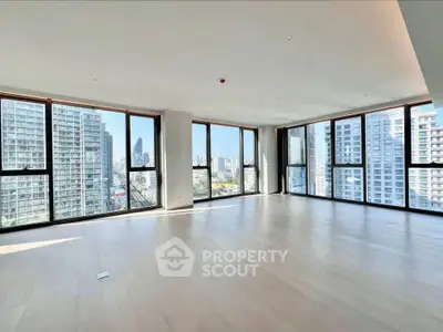 Spacious corner unit with panoramic city views and floor-to-ceiling windows in modern high-rise.