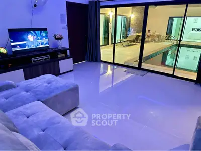 Luxurious living room with pool view and modern entertainment setup