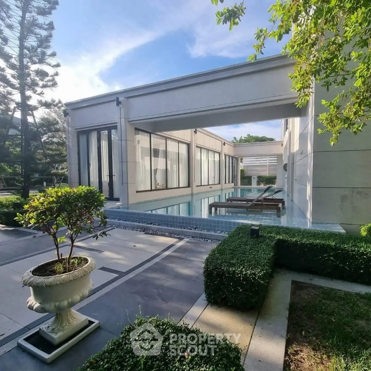 Luxurious modern villa with private pool and lush garden, perfect for serene living.