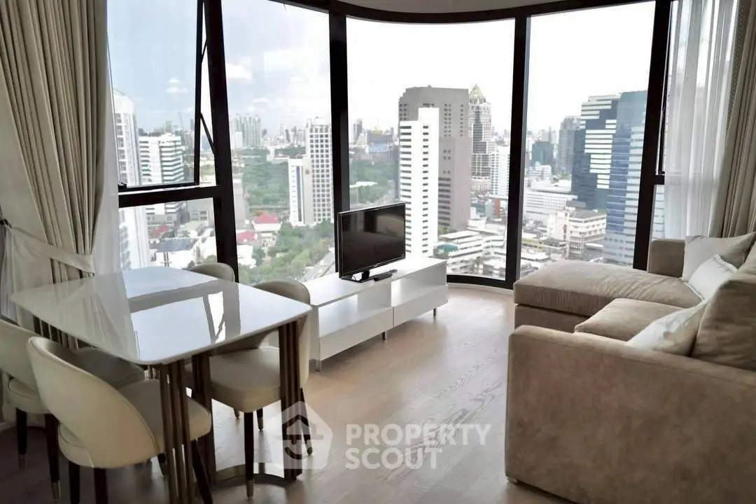 Luxurious high-rise living room with panoramic city views and modern furnishings.