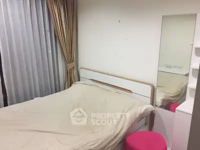 Cozy bedroom with modern furnishings and large window for natural light