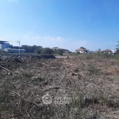 Vacant land plot with clear sky, ideal for development opportunities.