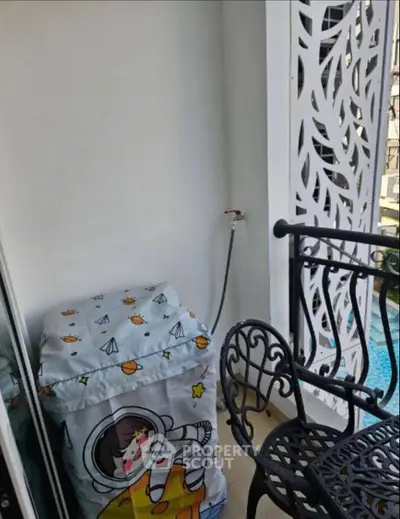 Charming balcony with decorative railing and pool view, perfect for relaxation.