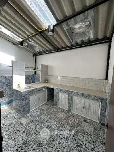 Charming kitchen with unique tile design and ample natural light.