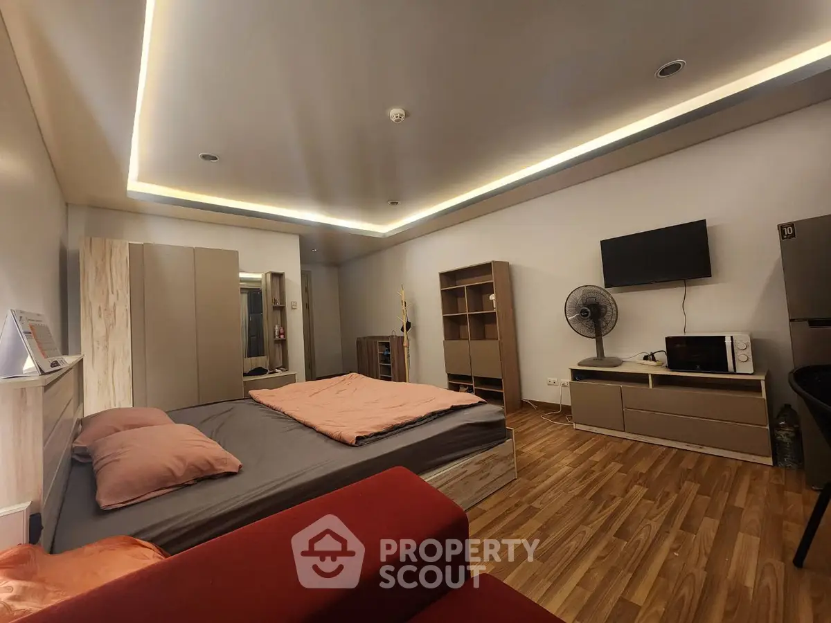 Modern bedroom with stylish lighting and wooden flooring