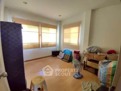 Cozy room with wooden flooring and ample natural light, ideal for versatile use.