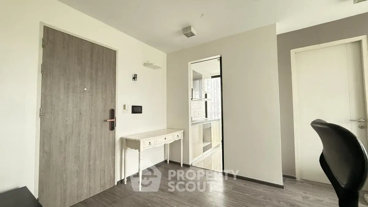 Modern minimalist interior with sleek wooden flooring and elegant furniture.
