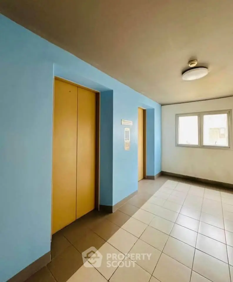 Bright and clean elevator lobby with modern design and natural light.