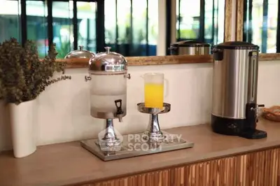 Modern kitchen counter with beverage dispensers and stylish decor
