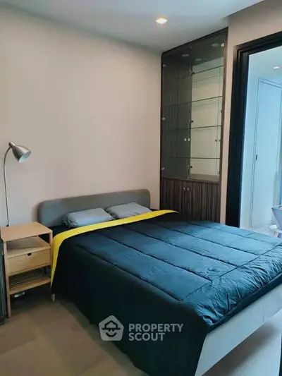 Modern bedroom with sleek design and cozy ambiance, featuring a stylish bed and elegant lighting.