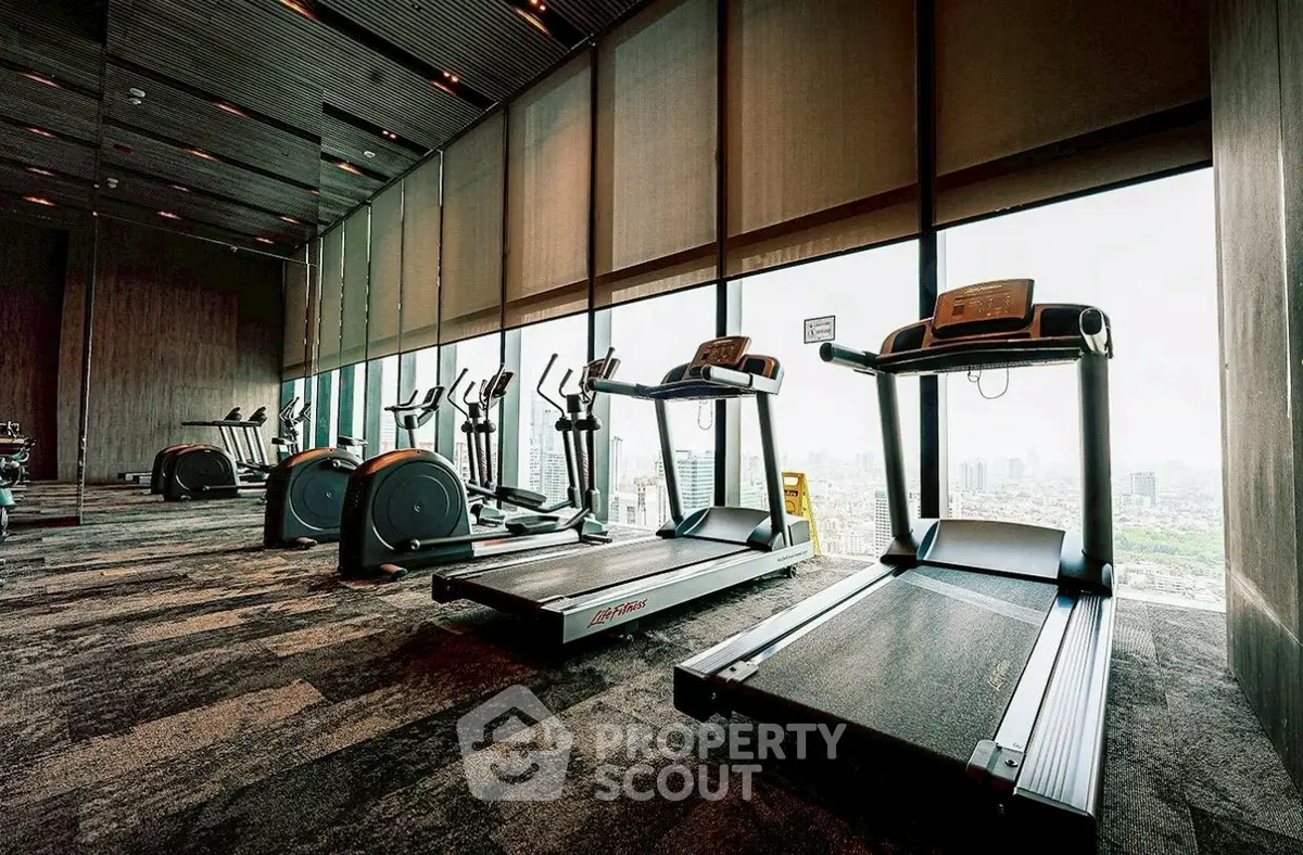 Luxurious high-rise gym with panoramic city views and modern fitness equipment.