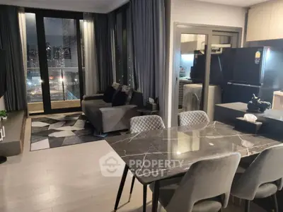 Modern open-plan living room with city view and stylish kitchen