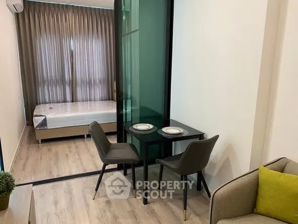 Modern studio apartment with cozy dining area and bedroom