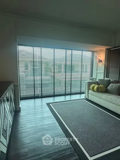 Modern living room with large windows and stylish decor