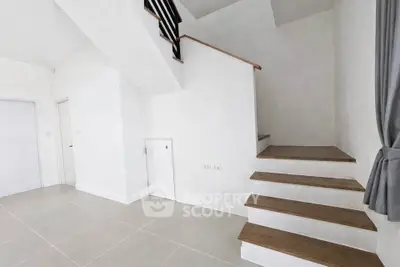 Modern minimalist interior with staircase and white walls, perfect for contemporary living.