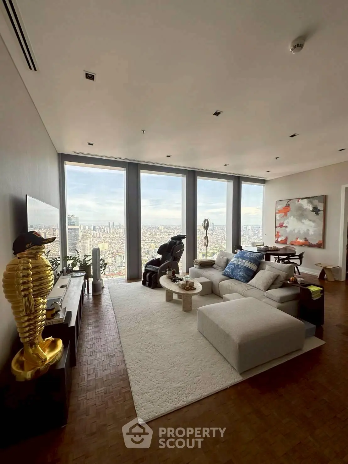 Luxurious living room with panoramic city view, modern decor, and stylish furniture in high-rise apartment.
